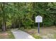 Carolina Reserve trail rules sign is visible on a sidewalk surrounded by lush trees at 4022 Perth Rd, Indian Land, SC 29707