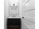 Modern bathroom with a black vanity, marble countertop, and stylish mirror at 419 Solomon St, Charlotte, NC 28216