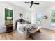 Bright bedroom features hardwood floors, large windows, and neutral decor at 419 Solomon St, Charlotte, NC 28216