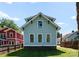 Back exterior view of home with light blue siding, black trim, and lush lawn at 419 Solomon St, Charlotte, NC 28216