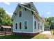 Rear exterior view showcasing the home's light blue siding and black trimmed windows at 419 Solomon St, Charlotte, NC 28216