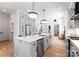 Bright, open kitchen features stainless appliances, a center island with seating, and hardwood floors at 419 Solomon St, Charlotte, NC 28216