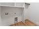 Convenient laundry area featuring built-in shelving and hardwood floors at 419 Solomon St, Charlotte, NC 28216