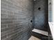 Modern shower with sleek gray tiling, a built-in seat, and contemporary black fixtures at 419 Solomon St, Charlotte, NC 28216
