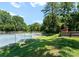 Backyard tennis court surrounded by mature trees, providing privacy at 419 Solomon St, Charlotte, NC 28216