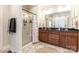 Large bathroom with double sink vanity, glass enclosed shower, and decorative rug at 4203 Flint Dr, Lancaster, SC 29720