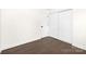 Bedroom with hardwood floors, a closet, and clean, minimalist design at 4219 Tipperary Pl, Charlotte, NC 28215