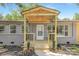 Charming home entrance with a wood porch and gray brick facade at 4219 Tipperary Pl, Charlotte, NC 28215