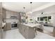 Modern kitchen with stainless steel appliances and a center island, seamlessly flowing into the living area at 4219 Tipperary Pl, Charlotte, NC 28215