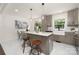 Open kitchen with marble countertops, an island with seating, and a dining area at 4219 Tipperary Pl, Charlotte, NC 28215