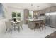 Bright kitchen with white tile floors, stainless steel appliances, and a cozy breakfast nook at 4219 Tipperary Pl, Charlotte, NC 28215