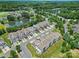 Aerial view showcasing a vibrant community with lush trees, serene lake, and manicured lawns at 44424 Oriole Dr # 200, Indian Land, SC 29707