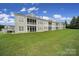 View of the townhome exteriors showing screened porches overlooking the well maintained backyard at 44424 Oriole Dr # 200, Indian Land, SC 29707