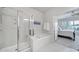 Bathroom featuring a shower, soaking tub, and access to the main bedroom with carpet flooring at 44424 Oriole Dr # 200, Indian Land, SC 29707