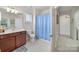 Bright bathroom features updated fixtures, natural light, and a blue shower curtain at 44424 Oriole Dr # 200, Indian Land, SC 29707