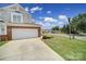 Exterior view of the garage, driveway, and well-manicured lawn at 44424 Oriole Dr # 200, Indian Land, SC 29707