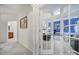 Bright hallway leading to a well-lit office featuring glass French doors at 44424 Oriole Dr # 200, Indian Land, SC 29707