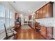 View of the kitchen with cherry cabinets, stainless appliances, hardwood floors, and access to the dining and living area at 44424 Oriole Dr # 200, Indian Land, SC 29707