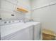 Laundry room showcasing a washer and dryer with white cabinets and tile floors at 44424 Oriole Dr # 200, Indian Land, SC 29707