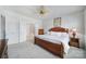 Spacious main bedroom showcasing neutral walls, carpet flooring, a ceiling fan, and an ensuite bath at 44424 Oriole Dr # 200, Indian Land, SC 29707