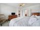 Bright main bedroom featuring neutral walls, carpet flooring, a ceiling fan, and access to an ensuite bath at 44424 Oriole Dr # 200, Indian Land, SC 29707