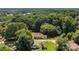 Aerial view of property highlighting the house and large lot surrounded by mature trees, offering a peaceful setting at 509 8Th Avenue Ext, Cramerton, NC 28032