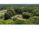 Overhead view of a quaint home nestled among lush trees providing privacy and a sense of natural beauty at 509 8Th Avenue Ext, Cramerton, NC 28032