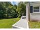 View of the back porch with access to the green lawn and mature trees in the backyard at 509 8Th Avenue Ext, Cramerton, NC 28032