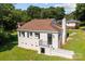 Back of a charming house with a walk out basement door, lush green grass and mature trees at 509 8Th Avenue Ext, Cramerton, NC 28032