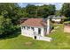View of the back of the white brick home featuring a backyard with lush green grass and mature trees at 509 8Th Avenue Ext, Cramerton, NC 28032