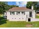 Back of a cozy single-story home with a walk out basement and lush green backyard at 509 8Th Avenue Ext, Cramerton, NC 28032