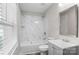Bathroom featuring a shower with marble tile, modern sink, and a window for natural light at 509 8Th Avenue Ext, Cramerton, NC 28032