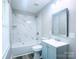 Updated bathroom featuring white tile and new fixtures at 509 8Th Avenue Ext, Cramerton, NC 28032