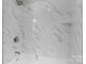 Close up of a full tub and shower with decorative marble tile at 509 8Th Avenue Ext, Cramerton, NC 28032