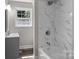 Modern bathroom featuring marble tile shower, sleek vanity, and a bright window at 509 8Th Avenue Ext, Cramerton, NC 28032