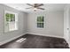 Bright bedroom with two windows allowing ample sunlight, complemented by a ceiling fan at 509 8Th Avenue Ext, Cramerton, NC 28032