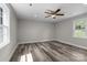 Bedroom with hardwood floor, ceiling fan, and natural light at 509 8Th Avenue Ext, Cramerton, NC 28032