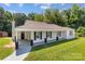 Lovely single-story home with a covered front porch, dark shutters and a lush green lawn at 509 8Th Avenue Ext, Cramerton, NC 28032