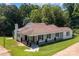 Aerial view of a single-story home with a sprawling lawn and mature trees in a peaceful setting at 509 8Th Avenue Ext, Cramerton, NC 28032
