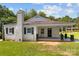 Home exterior featuring a white brick facade, covered porch, and landscaped front yard at 509 8Th Avenue Ext, Cramerton, NC 28032