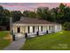 Charming single-story home featuring a welcoming front porch, brick facade, and beautiful landscaping at 509 8Th Avenue Ext, Cramerton, NC 28032