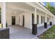 Inviting covered front porch with brick columns, offering a cozy outdoor space and curb appeal at 509 8Th Avenue Ext, Cramerton, NC 28032
