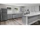 Well-lit kitchen featuring stainless steel appliances, sleek countertops, and stylish gray cabinets, perfect for cooking at 509 8Th Avenue Ext, Cramerton, NC 28032