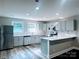 Bright, updated kitchen featuring stainless steel appliances and stone countertops with bar seating at 509 8Th Avenue Ext, Cramerton, NC 28032