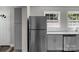 Kitchen featuring stainless steel refrigerator, modern white counters, and white cabinets at 509 8Th Avenue Ext, Cramerton, NC 28032