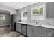 Updated kitchen boasts lots of natural light, stainless steel appliances, marble backsplash, and stylish countertops at 509 8Th Avenue Ext, Cramerton, NC 28032