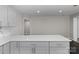 Kitchen with stainless steel handles on the modern cabinetry and white countertops at 509 8Th Avenue Ext, Cramerton, NC 28032