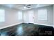 Living room featuring a ceiling fan, hardwood floors, and natural light from multiple windows at 509 8Th Avenue Ext, Cramerton, NC 28032