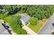 Aerial view of the home with a spacious yard, mature trees, and a large driveway at 666 Tryon Pl, Gastonia, NC 28054