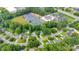 An aerial view of a community featuring mature trees, a school building, and residential streets at 666 Tryon Pl, Gastonia, NC 28054